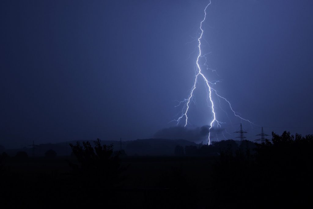 A picture showing a sky during a storm with lightning that has caused an electrical power cut